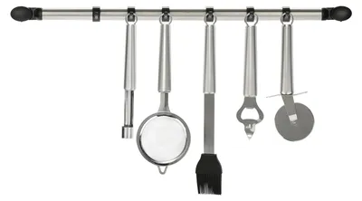 A set of kitchen utensils hanging on a rail.