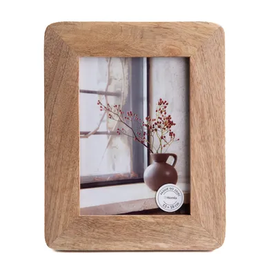 A wooden photo frame with a picture inside, placed on a white background.
