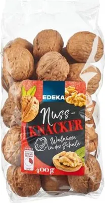 A clear plastic bag filled with walnuts, with a label on the front.