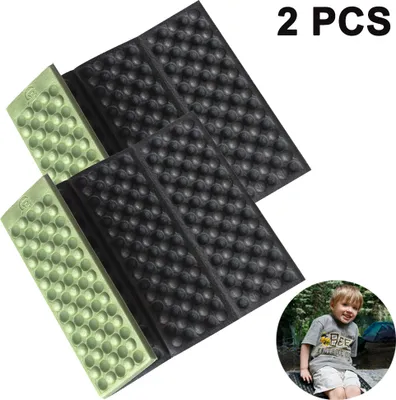 Two folding seat cushions and a child sitting in a campsite.