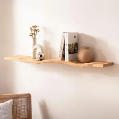 A wooden shelf mounted on a white wall, decorated with vases and books.