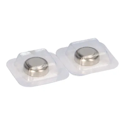 Two button cell batteries in clear plastic packaging against a white background.