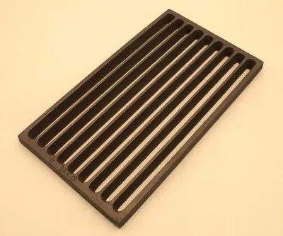 A dark gray cast iron grate with parallel slats is shown from a slightly elevated angle.