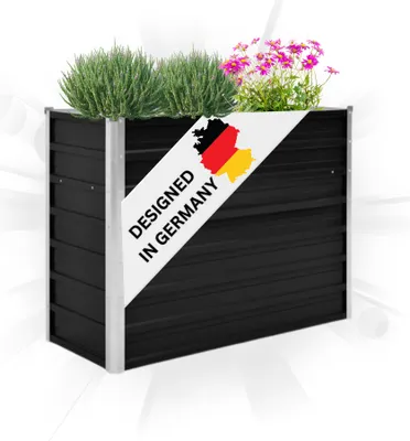 A black raised garden bed with plants and a decorative banner.