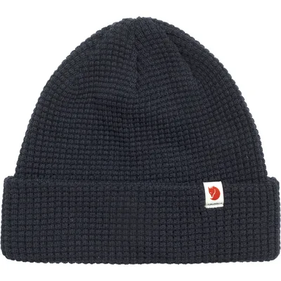 A dark navy knitted beanie with a small white logo patch on the front.
