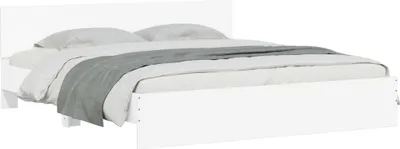 A white bed frame with bedding.