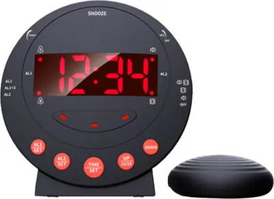 A black digital alarm clock with a red LED display and a separate vibrating disc.