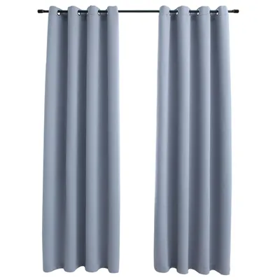 Two gray curtains hanging from a rod.