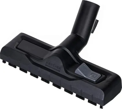 A black vacuum cleaner floor nozzle with a switch is shown against a white background.