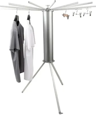 A silver rotating clothes drying rack with clothes hanging on it, set against a white background.