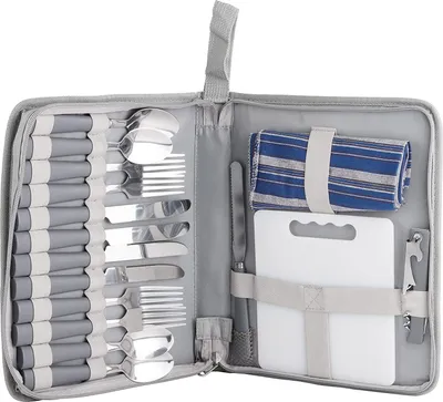 An open picnic cutlery set laid out flat, showing cutlery, a cutting board, and a rolled-up cloth.