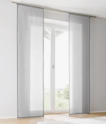 Panel curtains hanging in front of a window.