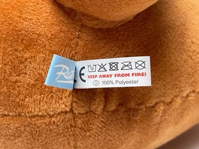 A close-up of a tag on a plush toy.