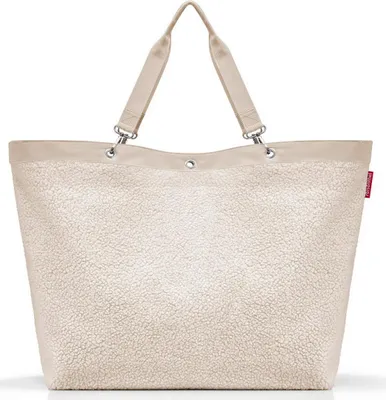A beige tote bag with a textured, fluffy exterior and a smooth beige trim and handles.