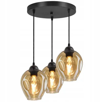 A three-light pendant chandelier with amber glass shades hangs from a black ceiling mount.