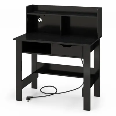 A black desk with a hutch, a drawer, and an open shelf, shown from the front with a power cord plugged in.
