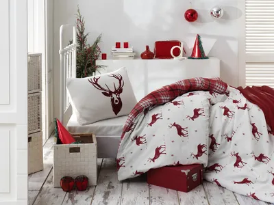 A cozy bedroom scene with Christmas-themed bedding and decor.