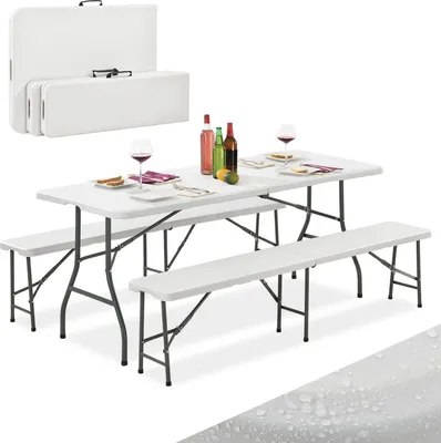 A white folding picnic table and two benches are set up with wine bottles and glasses on the table.