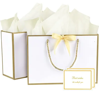 Productafbeelding van 2 cadeautasjes: papieren tasjes met strikken, 2 wenskaarten, 4 zakdoekjes, kleur: goudwit