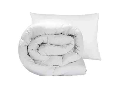 A rolled-up duvet and a pillow on a white background.
