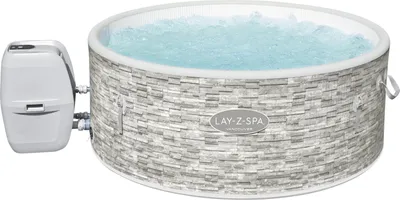 An inflatable hot tub filled with water and a control unit attached.