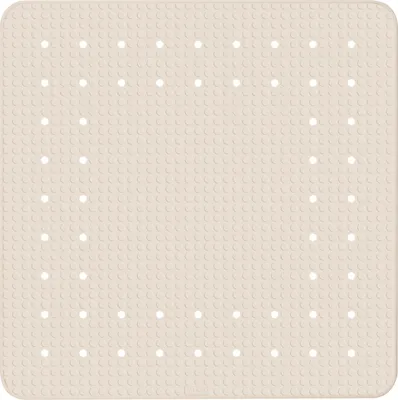 A top-down view of a beige shower mat with a grid of small circles and larger white dots.
