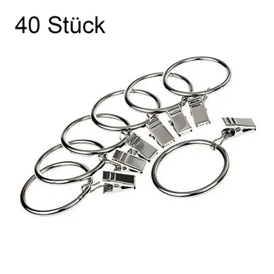 A pile of silver metal curtain rings with clips.