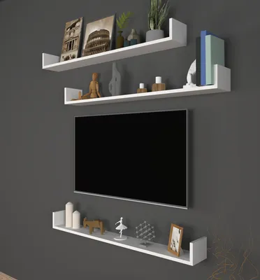 Three white U-shaped shelves mounted on a gray wall, with decorative items and a television on them.
