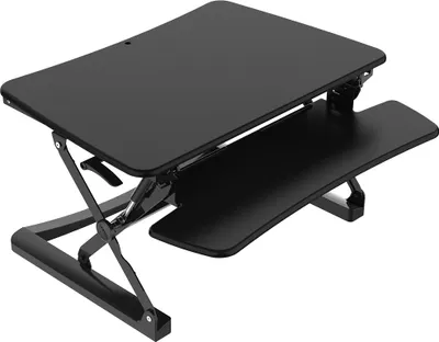 A black adjustable standing desk converter is shown from a slightly elevated diagonal angle against a white background.