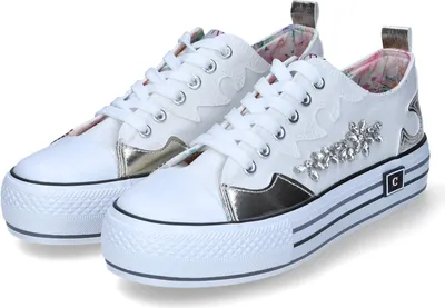 A pair of white sneakers with gold accents and embellishments.
