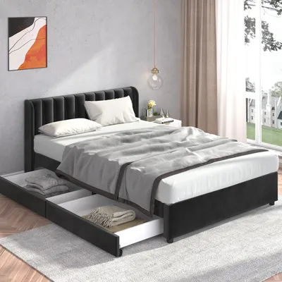 A bedroom scene featuring a black upholstered bed with drawers, a grey blanket, and a piece of abstract art on the wall.