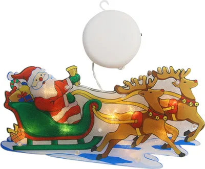 A Christmas-themed window decoration featuring Santa Claus in a sleigh pulled by reindeer, with lights.