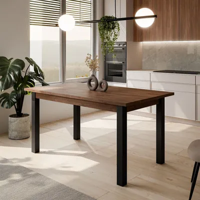 A dining table in a modern kitchen setting with a large window overlooking a landscape.