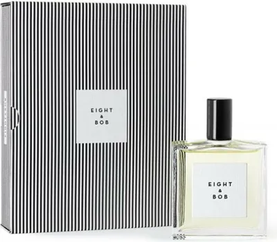 A perfume bottle and its box are displayed on a white background.