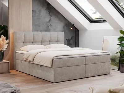 A bedroom with a bed, skylights, and a plant.