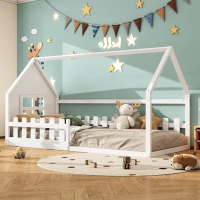 A child's bedroom with a white house-shaped bed, decorated with stars and a banner.