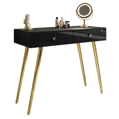 A black console table with gold legs and drawers, decorated with a mirror and cosmetic bottles.