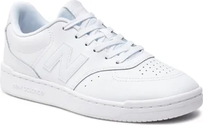 A white New Balance sneaker is shown from a side angle against a white background.