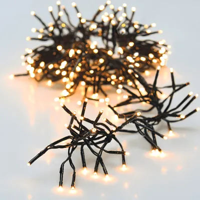 A cluster of warm white LED string lights on a white background.