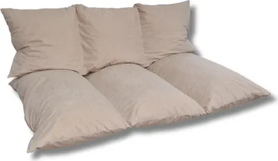 A set of beige cushions arranged on the floor.