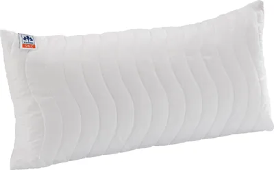 A white pillow with a wavy quilted pattern.