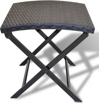 A black folding stool with a woven top and metal legs, shown from a slightly elevated side angle against a white background.