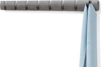 A wall-mounted coat rack with a blue scarf hanging on one of the hooks.