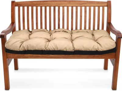 A beige cushion on a wooden bench.
