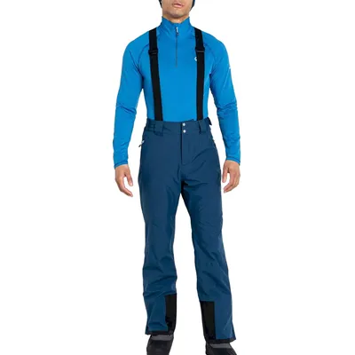 A person wearing a blue ski suit with black suspenders.