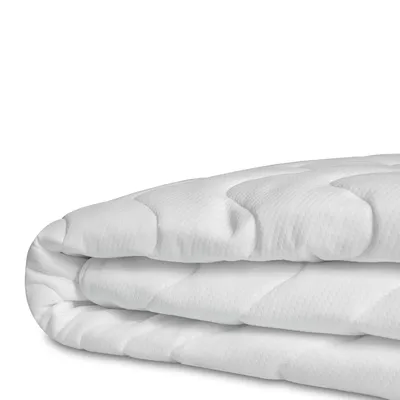 A folded white mattress topper on a white background.