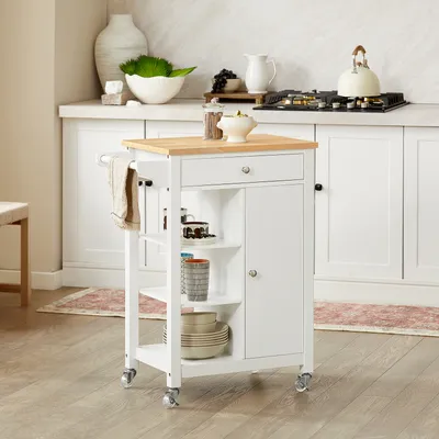 A white kitchen cart with a wooden top is shown in a kitchen setting.