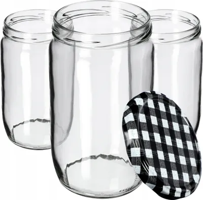 Three clear glass jars with a black and white checkered lid in front of them.