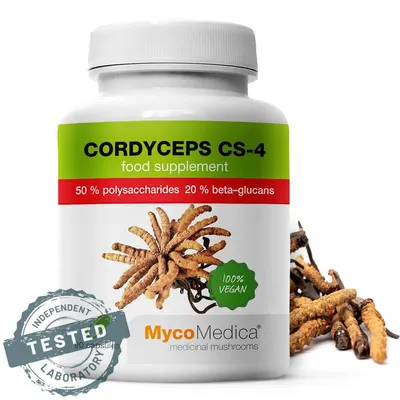 A bottle of Cordyceps CS-4 food supplement with some dried cordyceps mushrooms next to it.