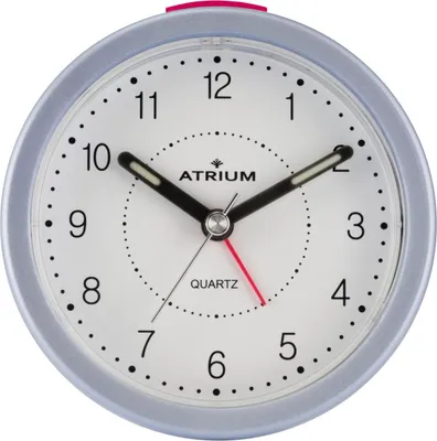 A close-up studio shot of an analog alarm clock.
